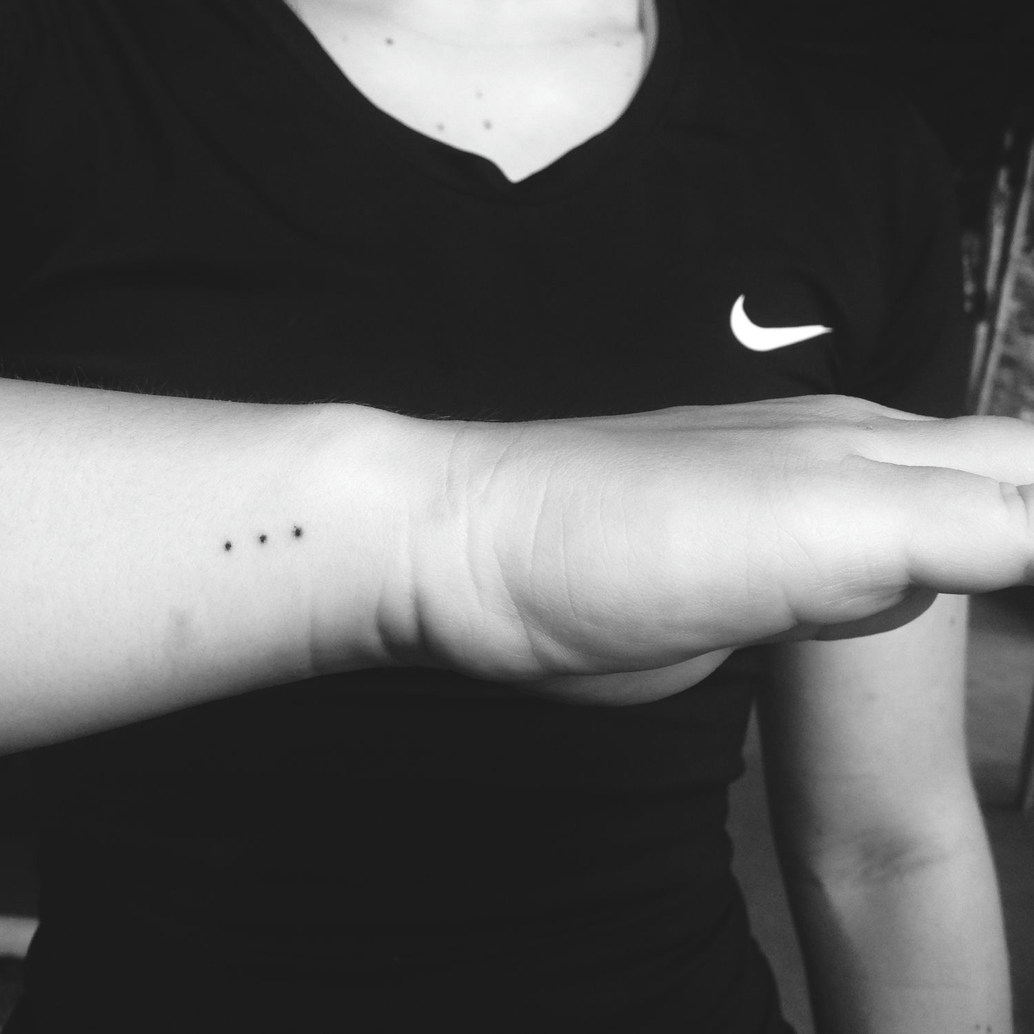 Tatouage minimaliste à trois points sur la main